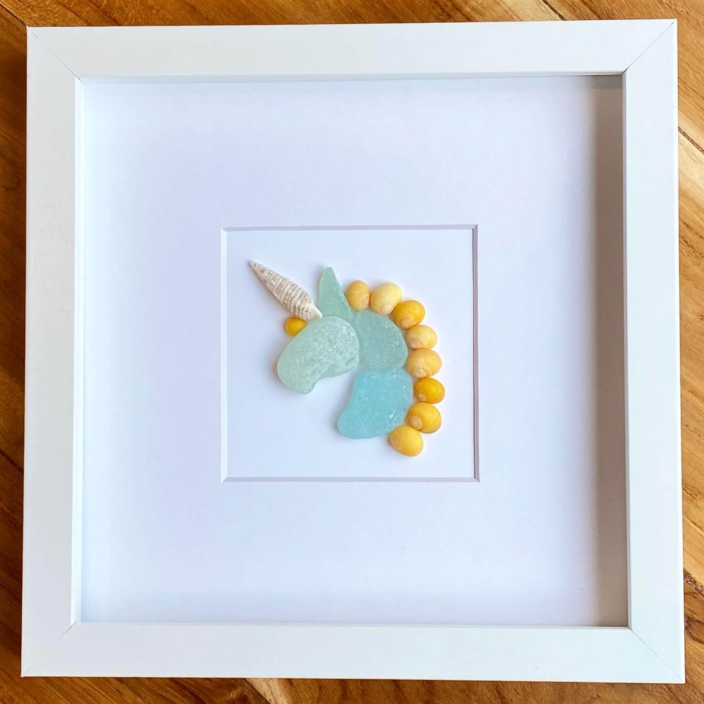 blue and yellow unicorn framed sea glass children's room decor