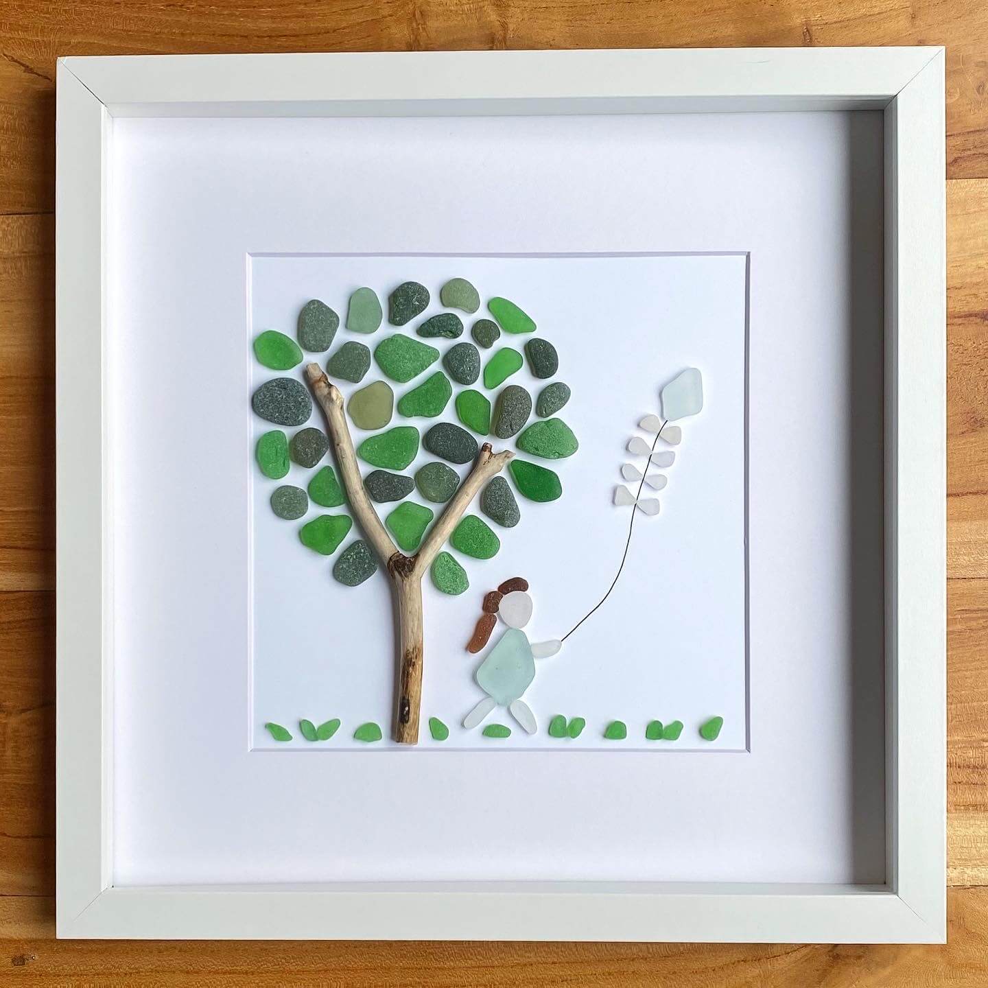 flying a kite under a tree seaglass artwork